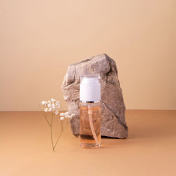 Close-up of drink on table against wall