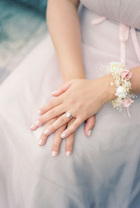 Midsection of bride holding wedding dress