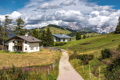 Houses on field against sky