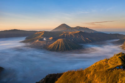 View of volcanic landscape against sky during sunset