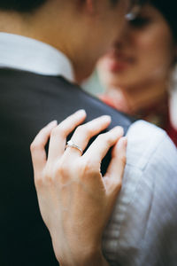 Midsection of couple holding hands