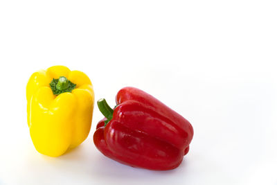 Close-up of yellow bell peppers on white background