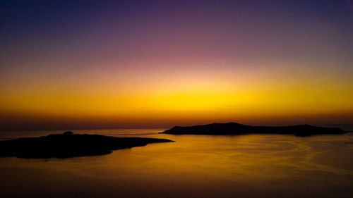 Scenic view of sea against orange sky