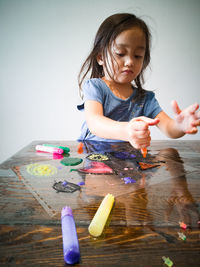 Cute girl playing with ball on table