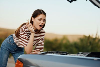 Side view of young woman using mobile phone