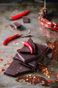 High angle view of red chili peppers and chocolates on table