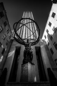 Low angle view of statue against building in city