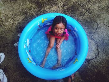 Girl playing water in a small pond