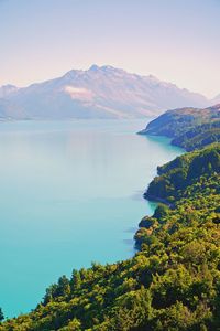 Scenic view of sea and mountains against sky