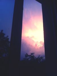 Low angle view of silhouette trees against sky at sunset