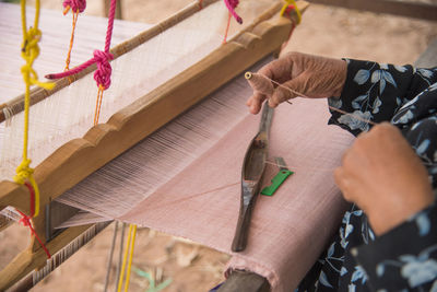 Midsection of man working on wood