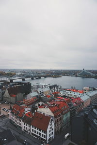 High angle view of buildings by sea against sky