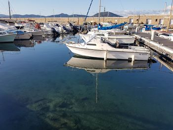 Boats moored in sea against sky