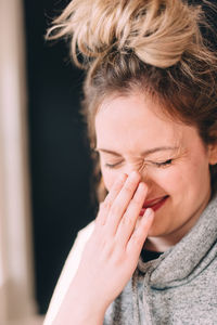 Young woman with eyes closed