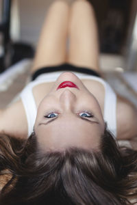 Smiling woman lying down at home