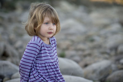 Close-up of girl against field