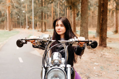 Portrait of woman wearing sunglasses against road