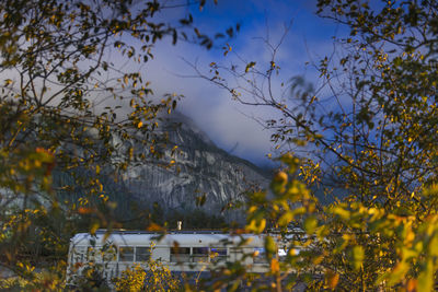 Converted school bus parked at night in front of mountain in squamish