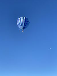 Low angle view of ferris wheel against blue sky