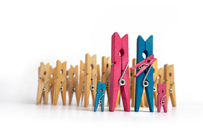 Close-up of multi colored clothespins against white background