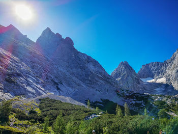 Scenic view of mountains against clear blue sky