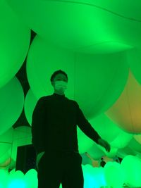 Full length of man standing on illuminated stage