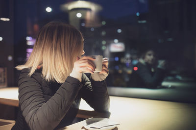 Woman having drink in cafe