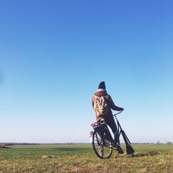 Person riding bicycle on field