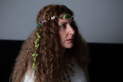 Portrait of young woman against white background