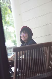 Close-up portrait of a girl standing against wall
