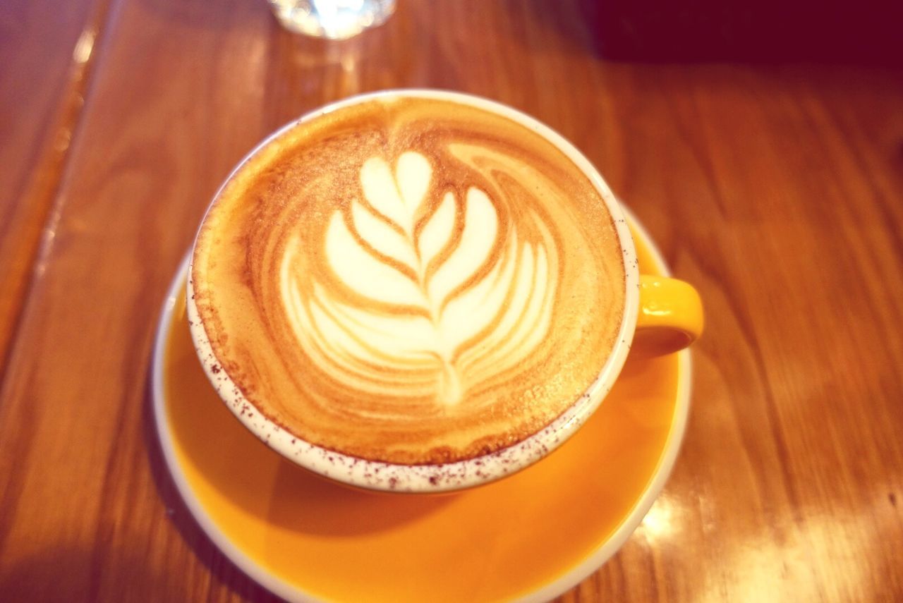 food and drink, indoors, coffee cup, froth art, freshness, table, refreshment, drink, frothy drink, cappuccino, coffee - drink, saucer, still life, close-up, high angle view, coffee, latte, design, pattern, directly above