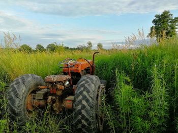 Tractor on field against sky