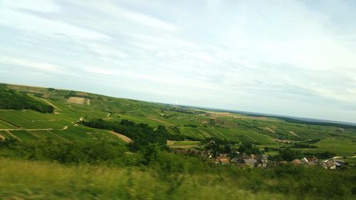 Scenic view of landscape against cloudy sky