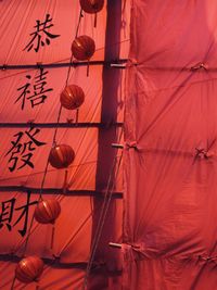 Low angle view of illuminated lanterns hanging in traditional building