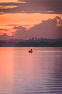 Scenic view of sea against orange sky