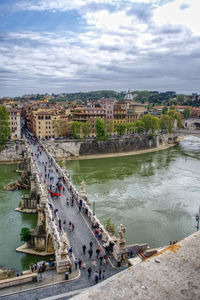 High angle view of townscape by river in city