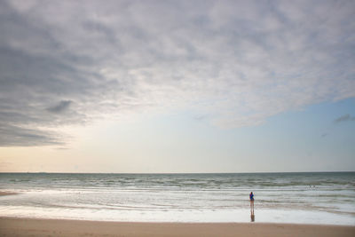 Scenic view of sea and silhouette against sky