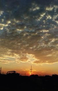 Silhouette buildings against sky during sunset