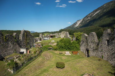 Scenic view of grassy landscape against blue sky