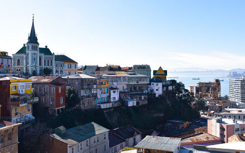 Buildings in city against clear sky