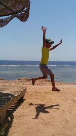 Woman jumping on beach