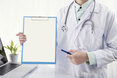 Midsection of man using mobile phone