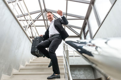 Businessman walking on staircase