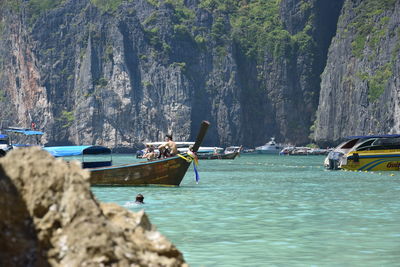 Boats moored on sea against sky