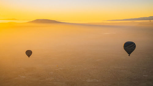 Hot air balloons against sky during sunset