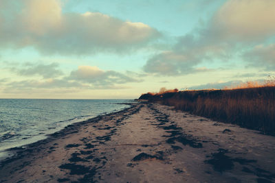 Scenic view of beach against sky during sunset