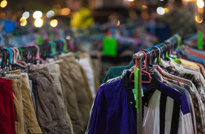 Close-up of multi colored shirts hanging at market