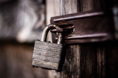 Close-up of padlock on wooden door