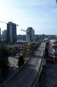 High angle view of city street and buildings against sky