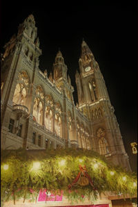 Low angle view of illuminated building against sky at night